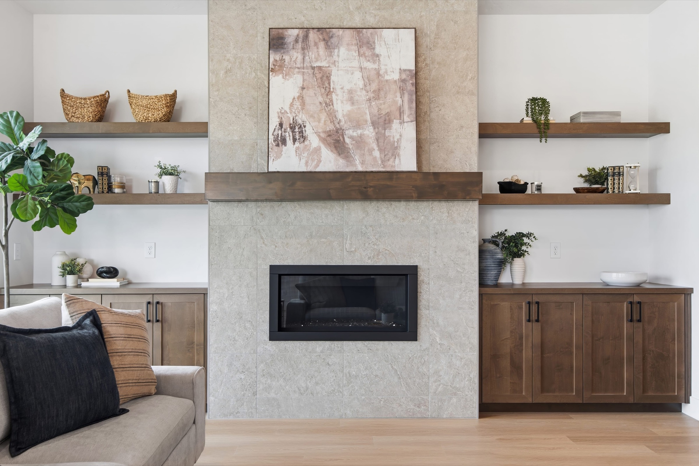 Contemporary fireplace wall with floating wood shelves and walnut built-ins